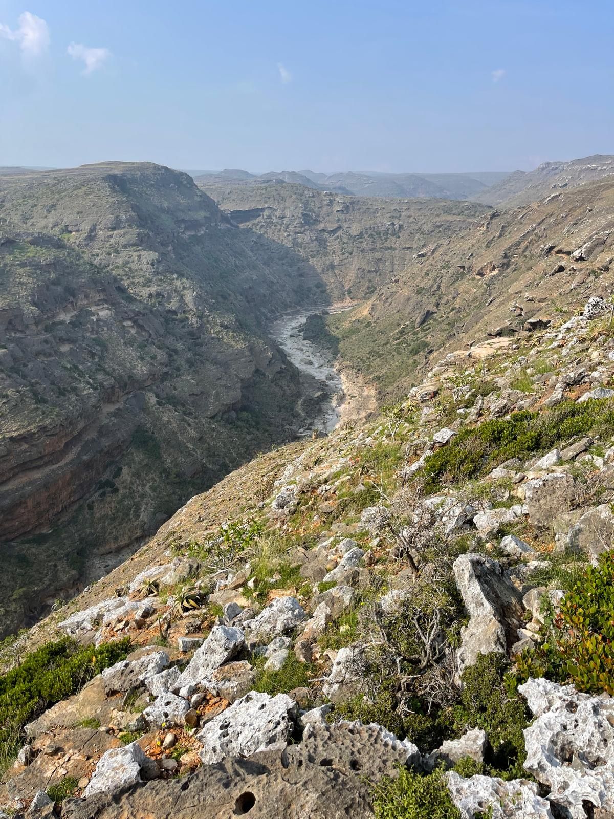 A deep limestone canyon with a dry river bed running along the bottom